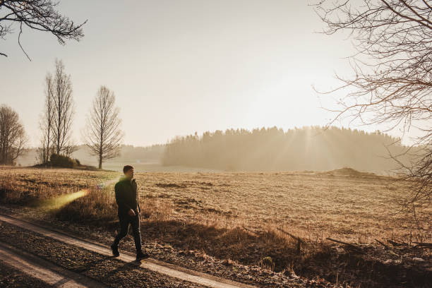istock Man outdoors walking in spring nature landscape 1132798131