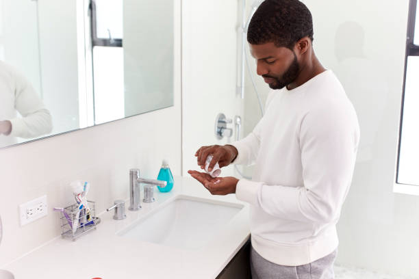istock Man In Bathroom Taking Vitamin Supplement Tablets 1132798247