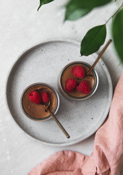 vegan Chocolate dessert with raspberries on marble background with copy space
