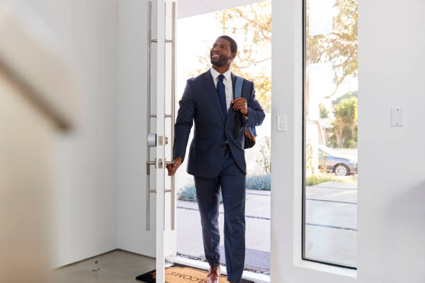istock Businessman Wearing Suit Opening Door Returning Home From Work 1132799831