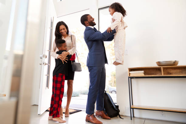 istock Children Greeting And Hugging Working Parents As They Return Home From Work 1132802099