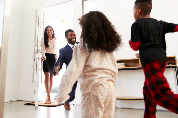 istock Children Greeting And Hugging Working Parents As They Return Home From Work 1132802788