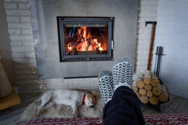 istock Burning fireplace and man feet 1132806904