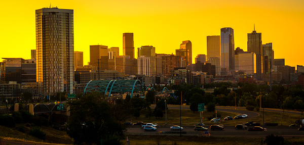 Gold colors over Denver Colorado skyline cityscape sunrise over the city amazing sunrise golden hour in the mile high city