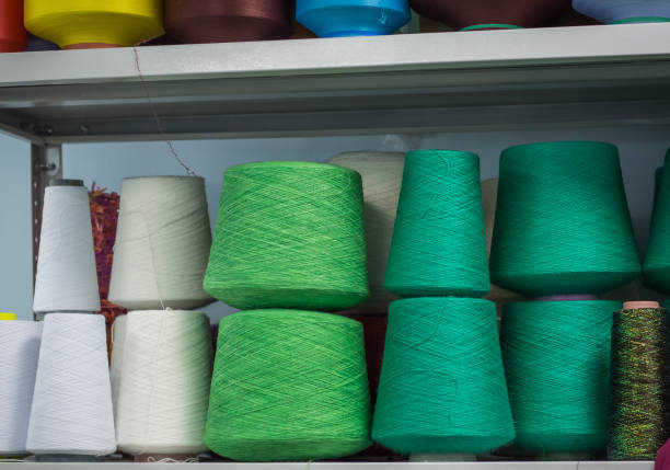 istock cotton and wool yarn on the spools on the shelf in the production 1132810372