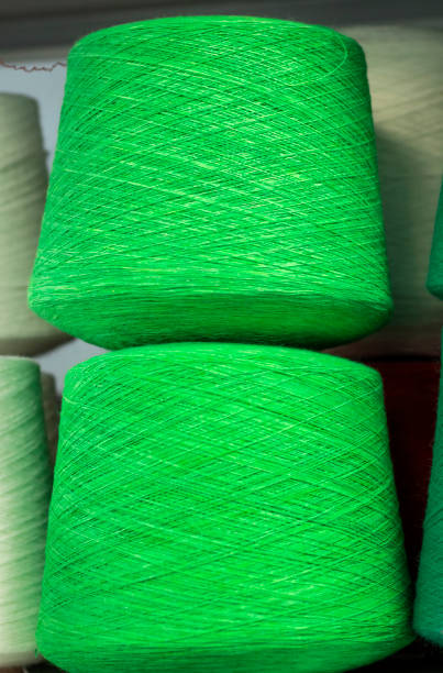 istock green cotton threads on the coils on the shelf in production 1132810389