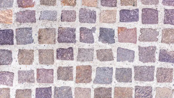 A floor covering with colorful paving stones as a background