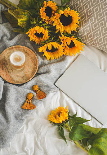 Cup with cappuccino, sunflowers, bedroom, morning concept, autumn