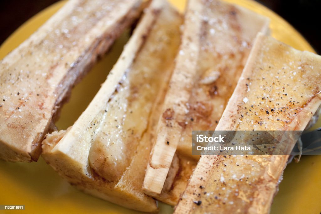 Marrow bones Roasted marrow bones arranged on a plate, ready to eat Bone Broth Stock Photo