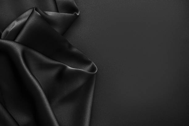 istock Black luxury wavy rippled glossy silk drapery cloth fabric 1132813409