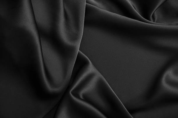 istock Black luxury wavy rippled glossy silk drapery cloth fabric 1132813724