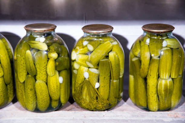 Glass jars with pickled cucumbers in the cellar