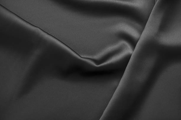 istock Black luxury wavy rippled glossy silk drapery cloth fabric 1132814970