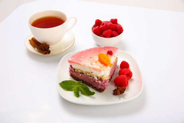 A Cup of tea and a dessert cake on the table on a light background.
