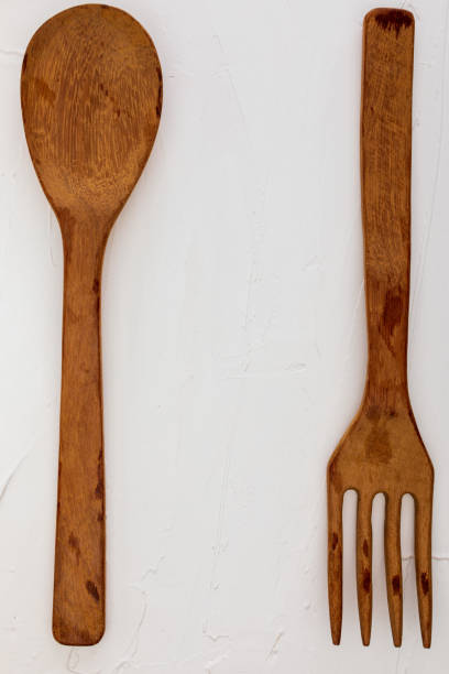 istock Wooden spoon and fork on white background with texture. Space to insert your text here. Letter for restaurants. (Food concept of spoon, pot). 1132825160