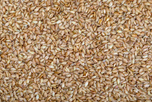 Background Golden flax seeds. Micronutrient beneficial for the organism that prevents and cures ailments. Rich in fiber and nutrients (manganese, vitamin B1, and above all, in omega-3 fatty acids) beneficial for healt (skin, weight loss, cholesterol reduction, celiac, antioxidants,"u2026)