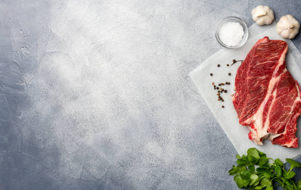 istock Raw meat. Raw beef steak on with cardamon and spices. Top view copy space. 1132827328