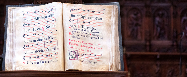 old gregorian book with letters decorated on parchment to sing in the choir