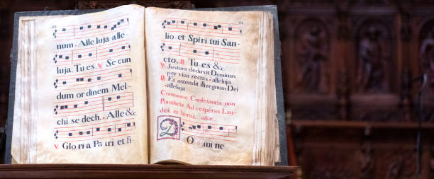 old gregorian book old gregorian book with letters decorated on parchment to sing in the choir chanting stock pictures, royalty-free photos & images