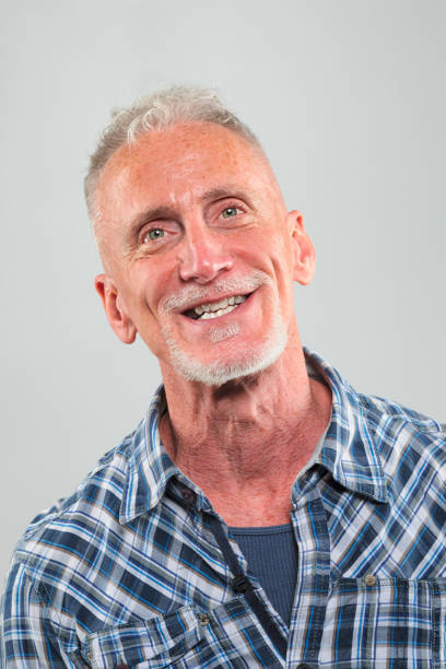 istock Mature man happy head shot on gray background 1132827923