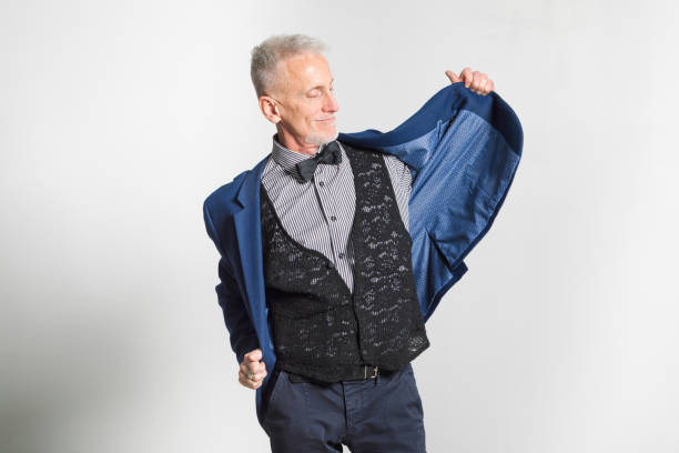 Mature man putting on his jacket smiling