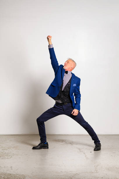 Mature man in a super hero pose full length