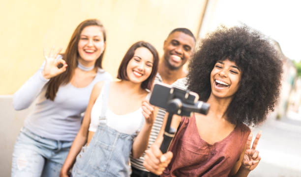istock Millennial people taking video selfie with stabilized mobile phone  - Young friends having fun on new tech trends - Youth and friendship concept with millenials sharing moments on social media network 1132829371