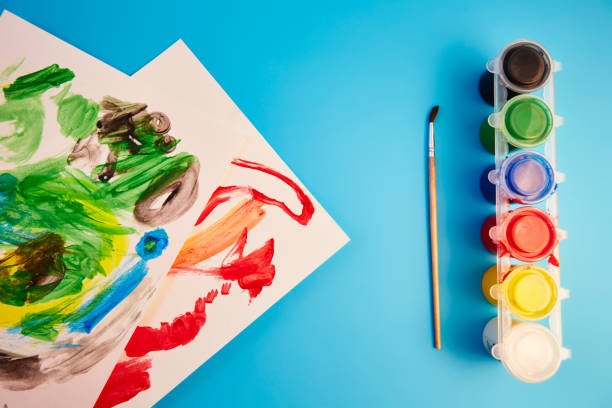 istock colored paints and children's drawings 1132829660
