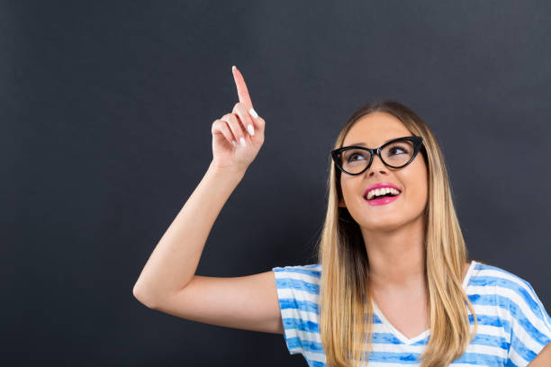 istock Young woman pointing at something 1132831262