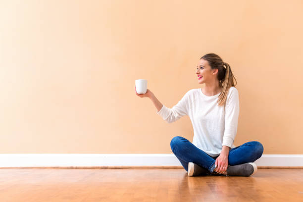 istock Young woman drinking a cup of coffee 1132831303