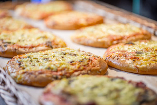 istock small pizzas and pastries in the basket on the bakery window 1132832376