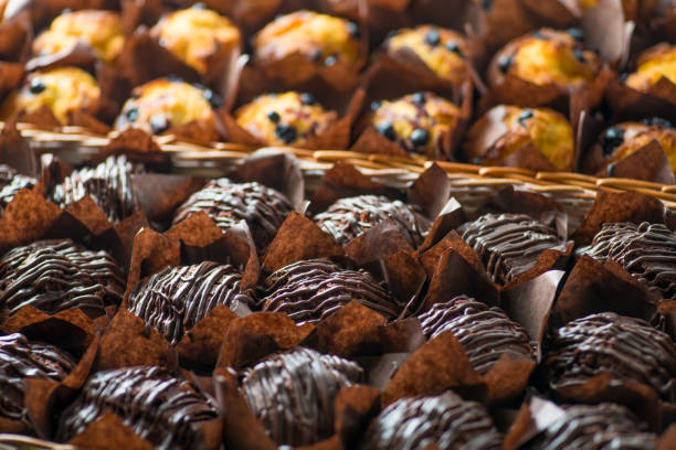 istock chocolate and berry cupcakes in a basket on the bakery window 1132832379