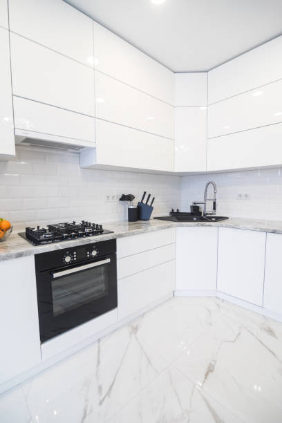 istock Minimalist, lacquer, white kitchen and modern wooden accessories. Disigh kitchen 1132832427