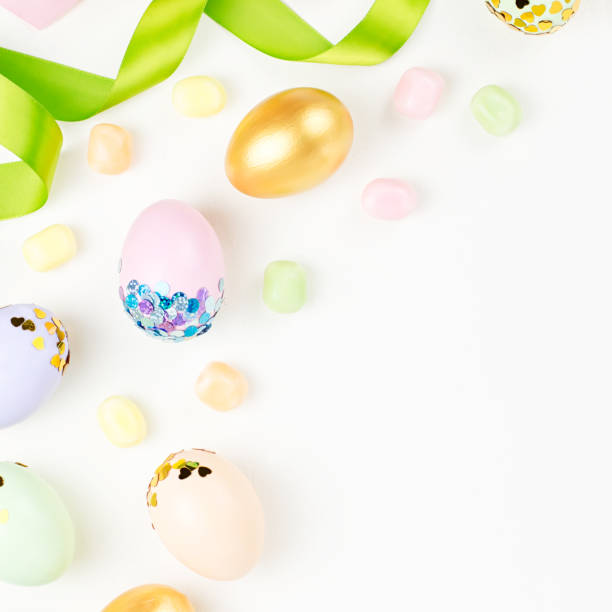 istock Festive Happy Easter background with decorated eggs, flowers, candy and ribbons in pastel colors on white. Copy space 1132833139