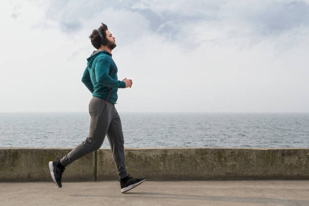 istock Active Young Man Jogging on A Foggy Winter Day 1132833814