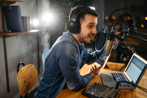 Talent for entertainment shows Photo of young man recording a podcast in a studio radio dj stock pictures, royalty-free photos & images