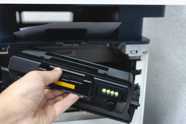 istock technician office worker fixing photocopy machine with replacement toner cartridge. refilling cartridge with toner for printing documents. 1132836740