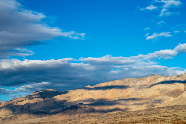 istock blue sky white clouds over desert hills Eastern Sierra Nevada, California, USA 1132838519