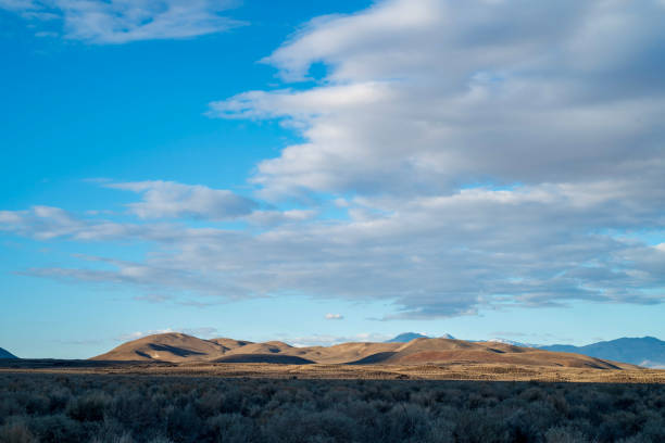 istock blue sky white clouds over desert hills Eastern Sierra Nevada, California, USA 1132838523
