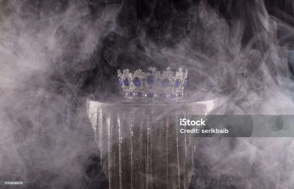 royal medieval crown in smoke Gold - Metal Stock Photo