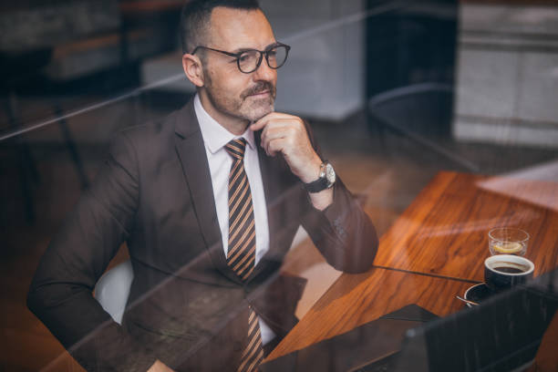 istock Senior man in a suit on a coffee break 1132839242