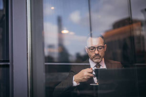 istock Serious businessman is drinking coffee 1132839296