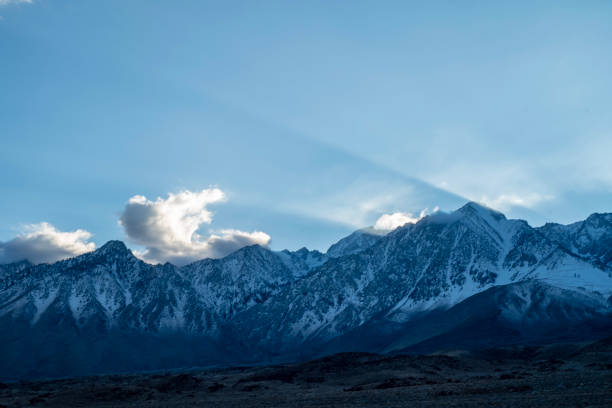 istock sunbeam rays of sunlight beaming over mountain peaks 1132839985