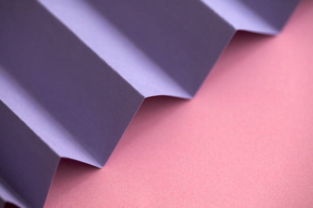 istock Purple diagonal folded paper on pink background 1132841231