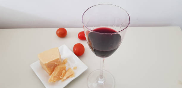 istock a glass of red vine on white table 1132841393