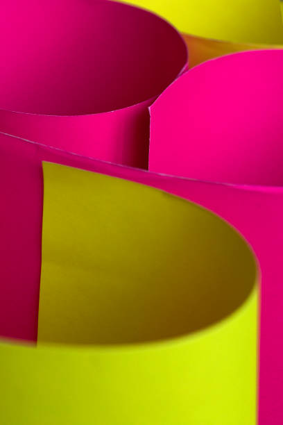istock Neon pink and yellow Curled paper background. 1132842844