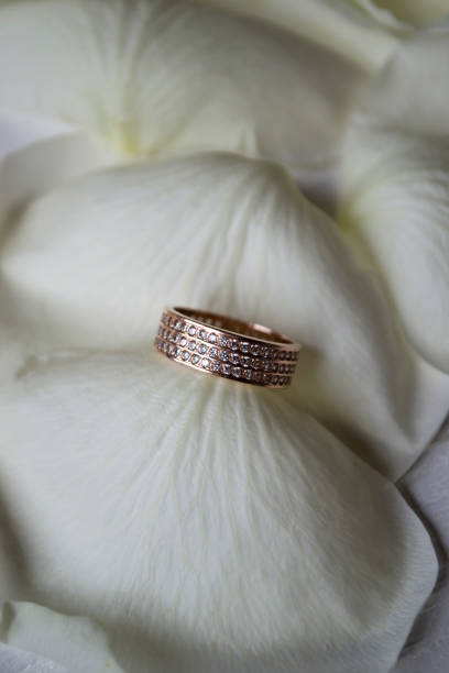 istock Wedding ring on white petals of roses. 1132844926
