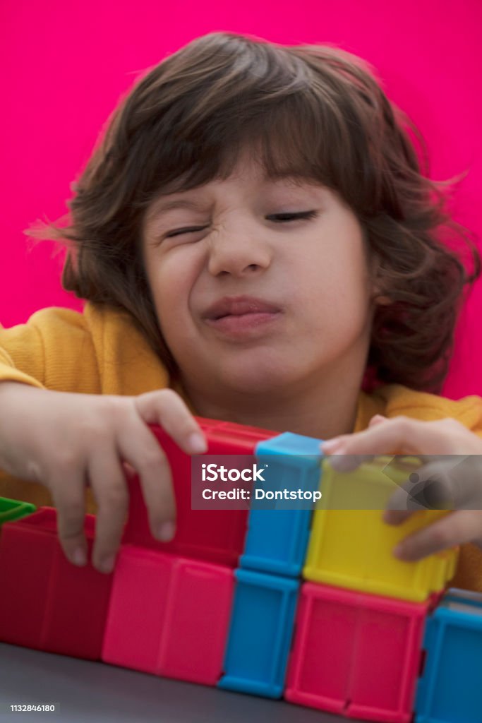 Happy Child Playing With Preschoolers Building Blocks Stock Photo