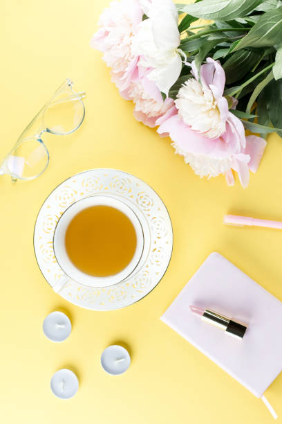 istock Beautiful cosmetics and flowers flat lay with note book, herbal tea on pastel background. 1132846203