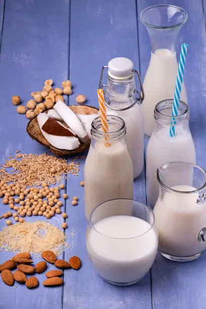 Photo of Various types of all-vegetable and organic milk in glass containers